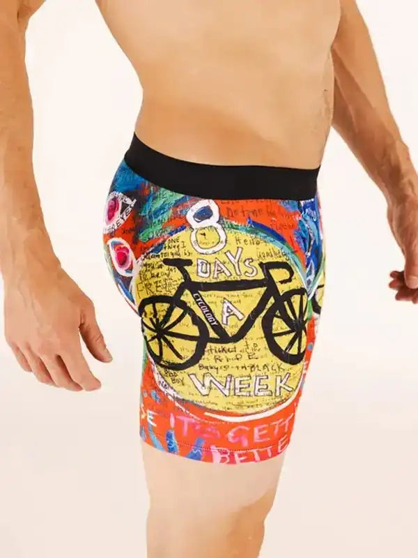 Men's cycling shorts with colorful '8 Days a Week' bike graphic design, ideal for road cycling comfort.