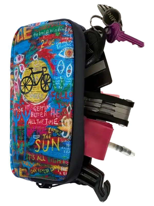Colorful cycling accessory pouch with bike graphics, holding keys and tools for riders