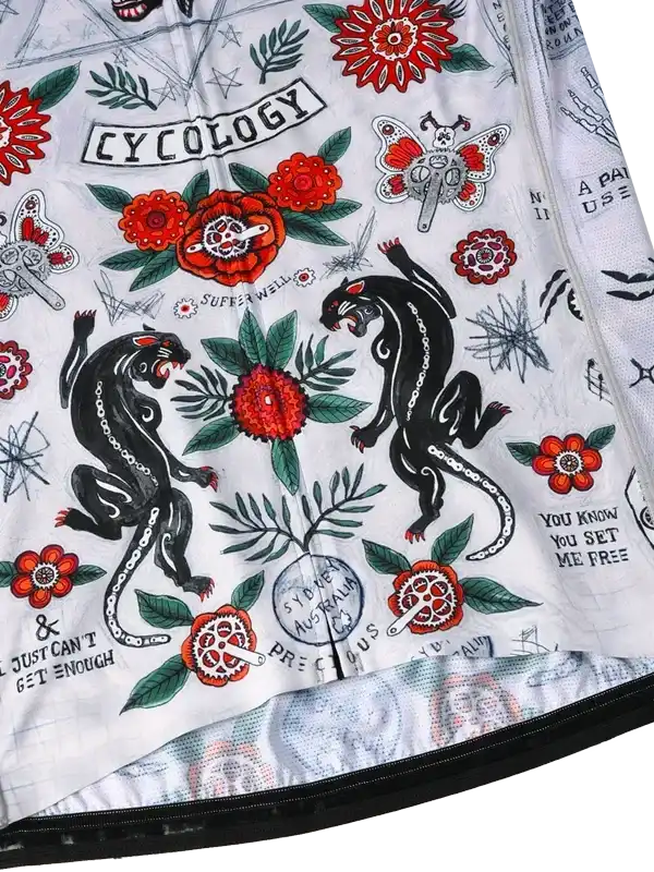Cycology cycling jersey with bold black panthers, red flowers, and tattoo-style graphics on white fabric