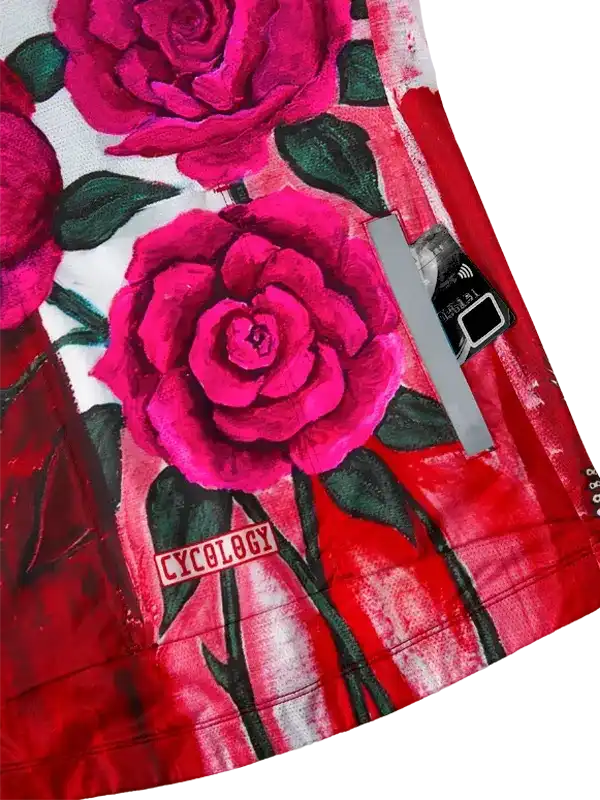 Vibrant pink rose print cycling jersey with red accents and Cycology logo, designed for women's bike wear.