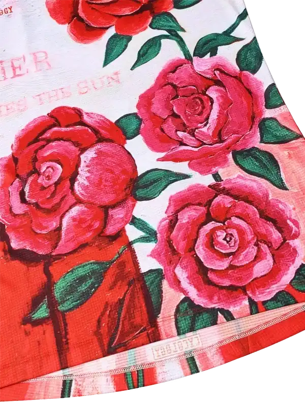 Vibrant red rose print cycling jersey with green leaves and bold design details