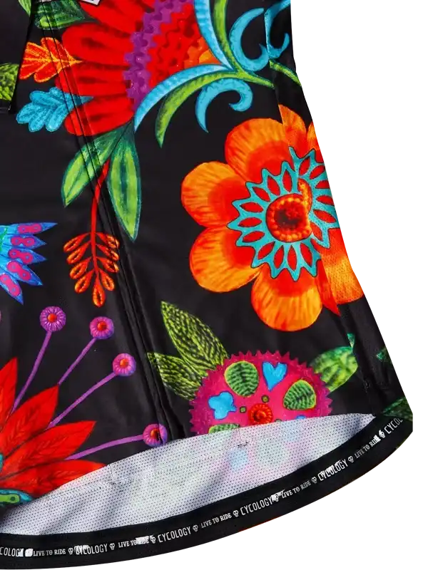 Vibrant floral cycling jersey with bold orange, red, and teal blooms on black fabric, featuring mesh hem and 'LIVE TO RIDE' trim