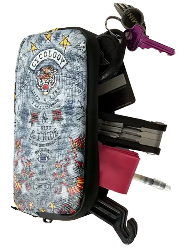 Cycology branded multi-tool pouch with tiger graphic, keys, and tools for cycling gear organization