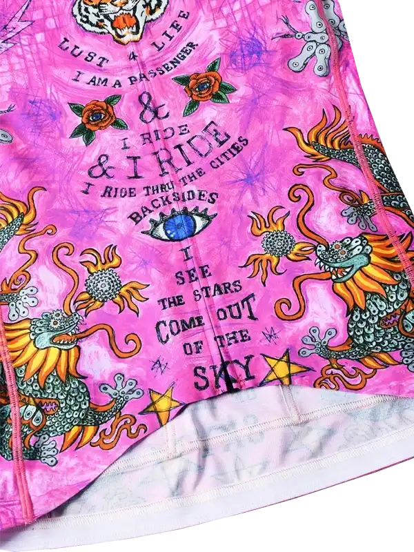 Pink cycling jersey with dragon, tiger, and tattoo-style graphics, featuring bold text and vibrant design.