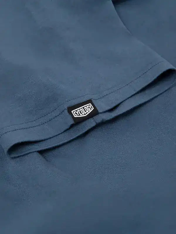 Cycology brand tag on blue cycling apparel, showcasing quality fabric and design detail