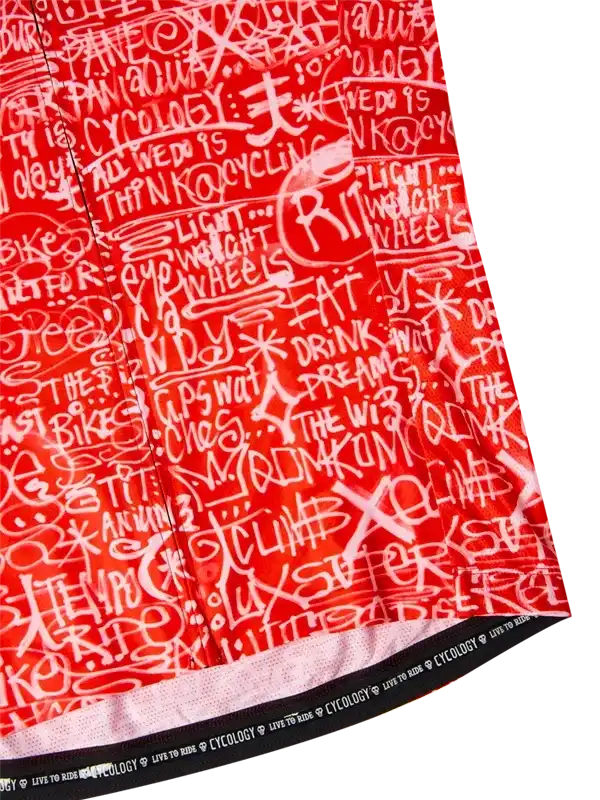 Red cycling jersey with white graffiti-style text design, featuring cycling phrases and 'Cycology' branding on hem.