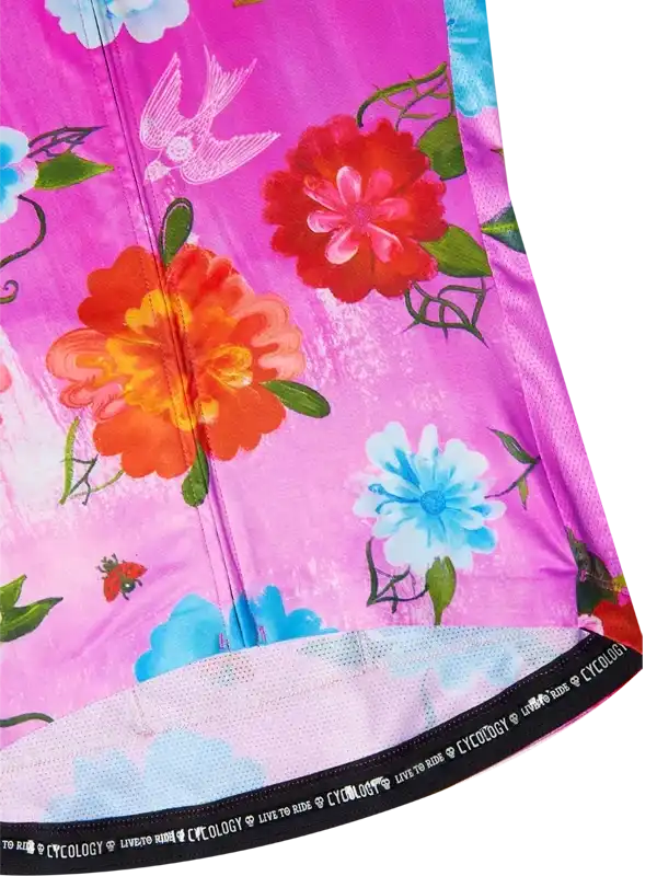 Vibrant floral cycling jersey with pink background, red and blue flowers, and bird print for women's bike wear
