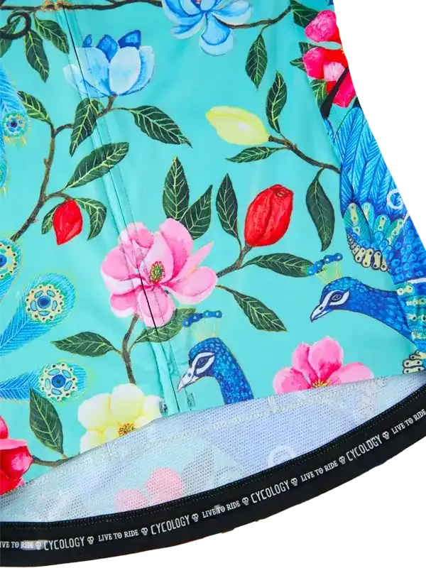 Floral and peacock print cycling shorts with vibrant turquoise background and mesh waistband