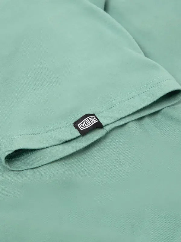Mint green cycling t-shirt with black brand tag, soft fabric detail for men's and women's bike wear