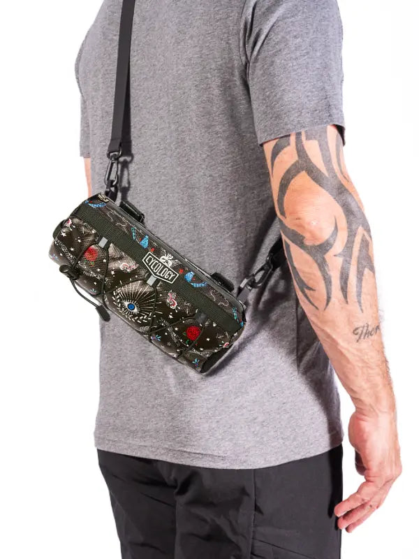 Person wearing a Black bike bag with colorful designs and 'Cycology' branding