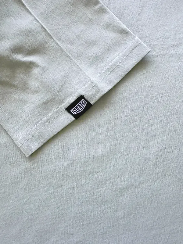 Light gray cycling t-shirt with black brand tag, soft fabric detail for men's and women's bike wear