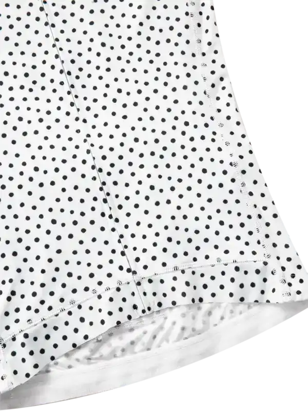 White cycling jersey with black polka dots, close-up of fabric and stitching detail