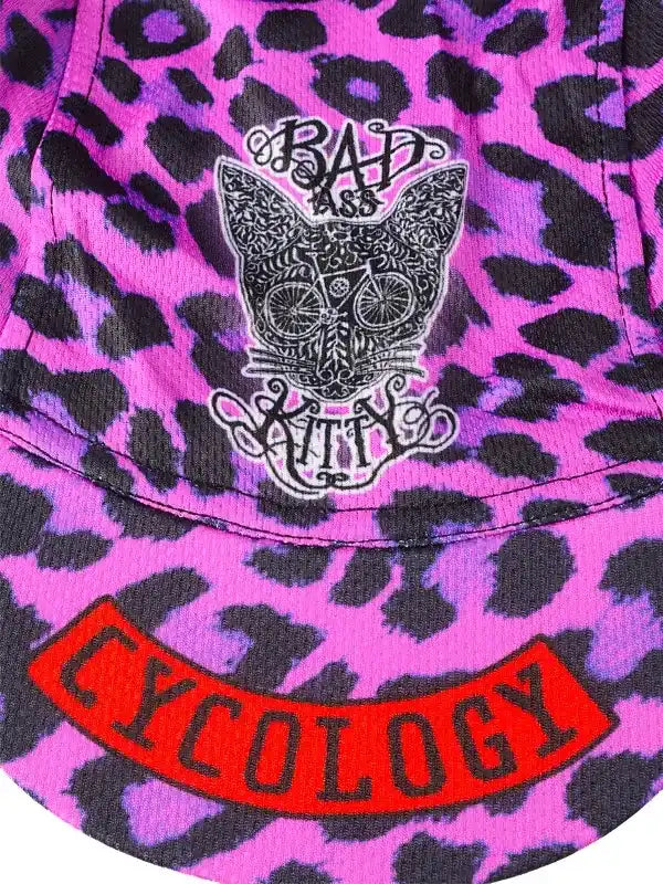 Pink leopard print cycling jersey with 'Bad Ass Kitty' cat graphic and red Cycology logo