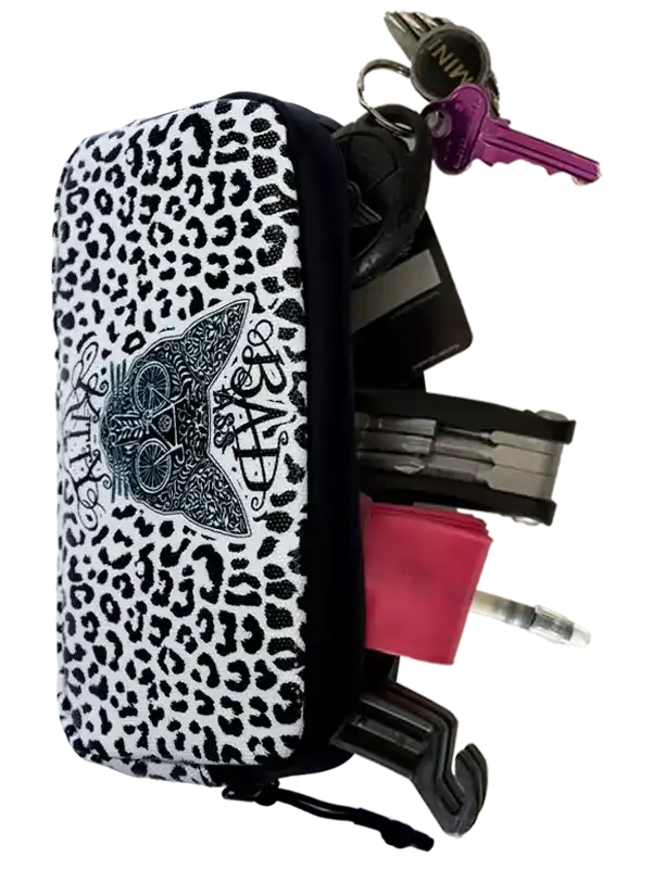 Leopard print cycling key pouch with cat graphic, holding keys and tools for bike riders