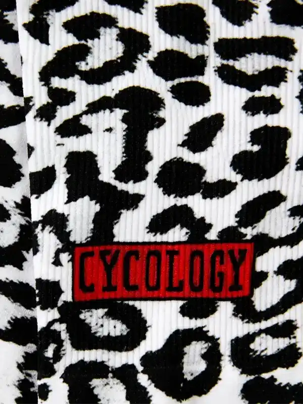 Cycology cycling socks with bold black and white leopard print and red brand patch