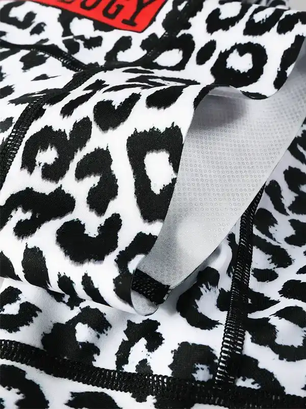 Black and white leopard print cycling shorts with mesh lining and red logo tag