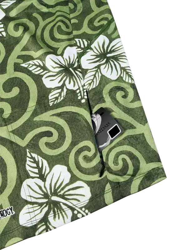 Green cycling shorts with white hibiscus flowers and swirl pattern, featuring rear pocket with zipper
