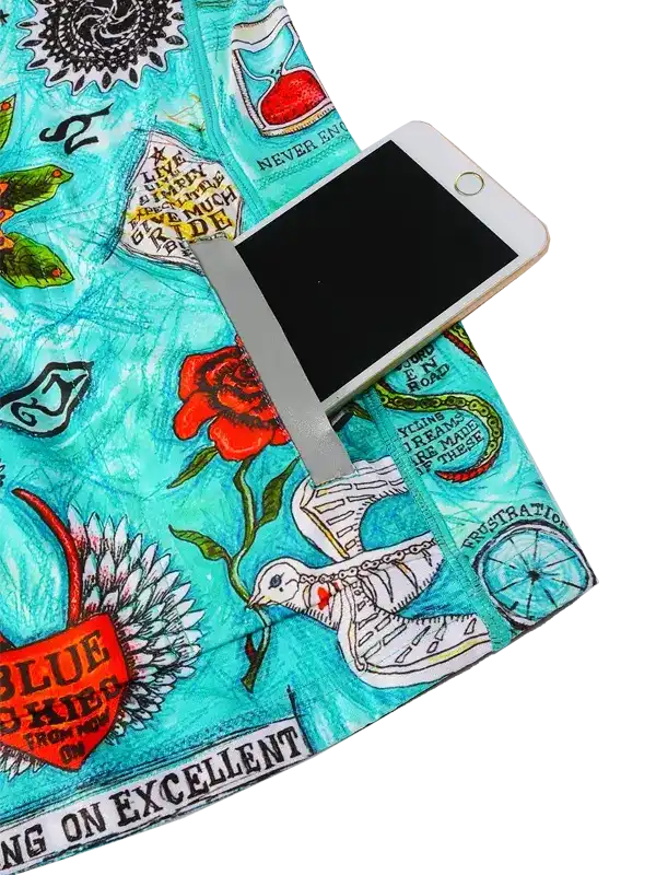 Cycling shorts with vibrant turquoise print, floral and quote designs, featuring phone pocket for riders