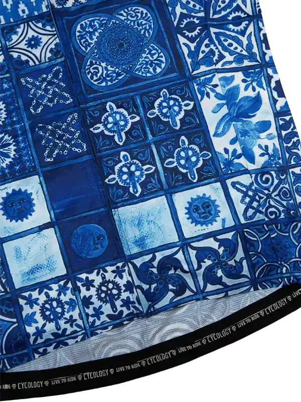 Blue and white patterned cycling jersey with tile-inspired designs and gear motifs, featuring 'Live to Ride' hem text.