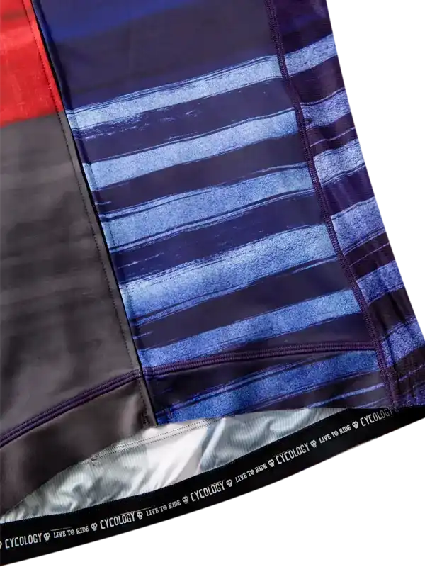 Men's cycling shorts with blue striped pattern, black panel, and 'CYCOLOGY LIVE TO RIDE' waistband