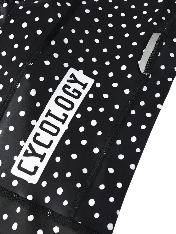 Black athletic outfit with white polka dots and 'Cycology' branding.