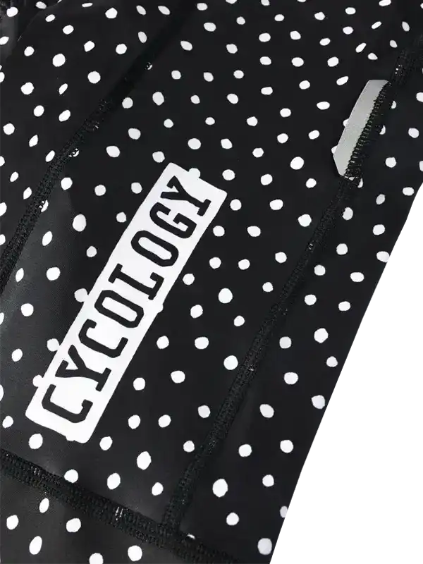 Black athletic outfit with white polka dots and 'Cycology' branding.