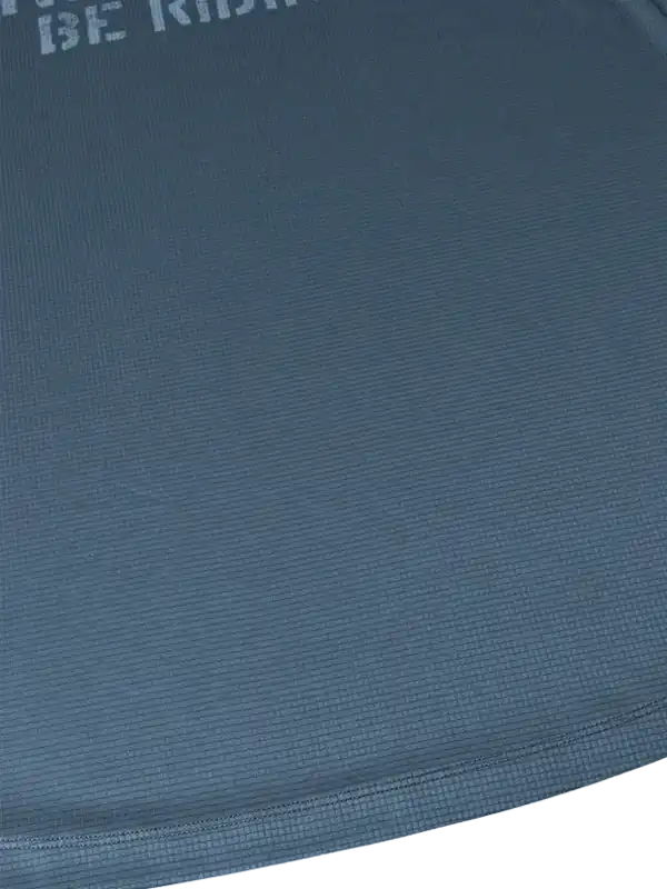 Close-up of blue cycling jersey fabric with 'BE RIDE' text, showcasing breathable texture for men's and women's bike wear.