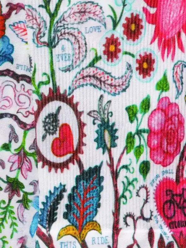 Colorful floral cycling apparel print with hearts, bikes, and 'Love This Ride' text on white fabric