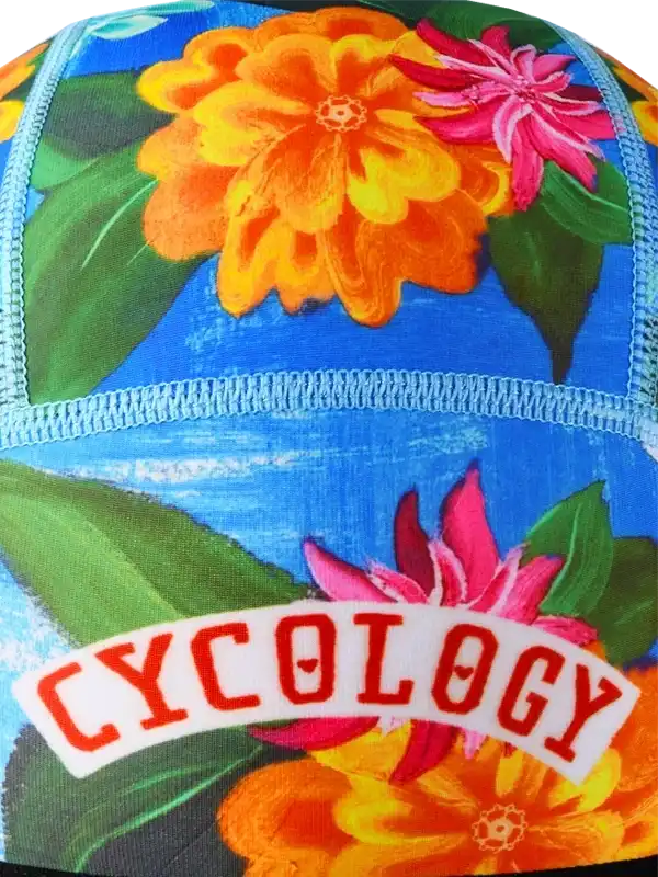 Cycology floral cycling cap with vibrant orange and pink flowers on blue background