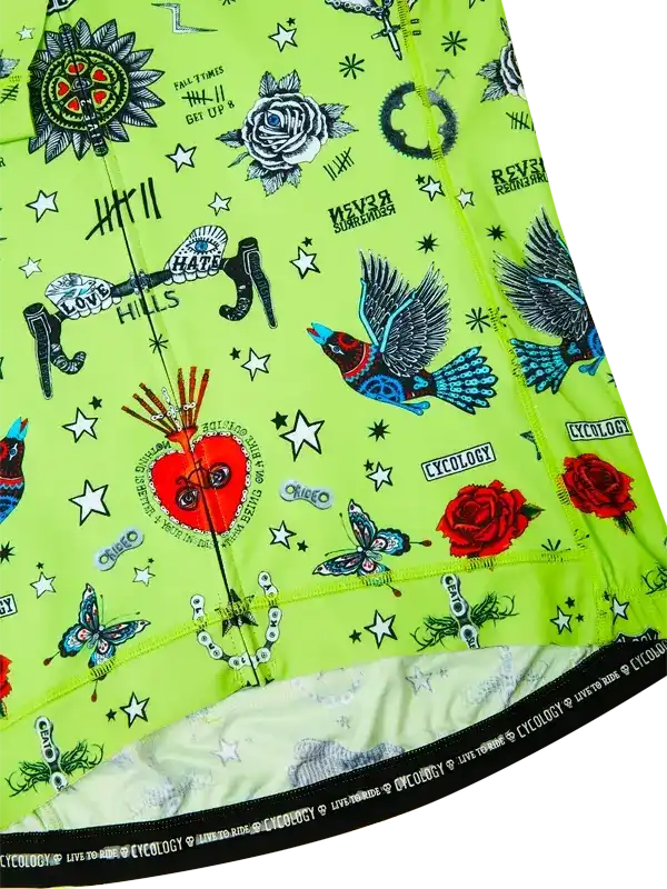 Vibrant green cycling jersey with tattoo-style graphics, roses, birds, and stars for men's and women's rides.