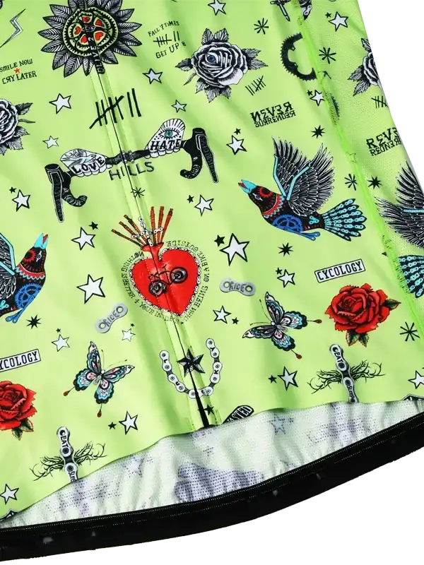 Vibrant green cycling jersey with tattoo-style graphics, roses, birds, and stars for men and women.