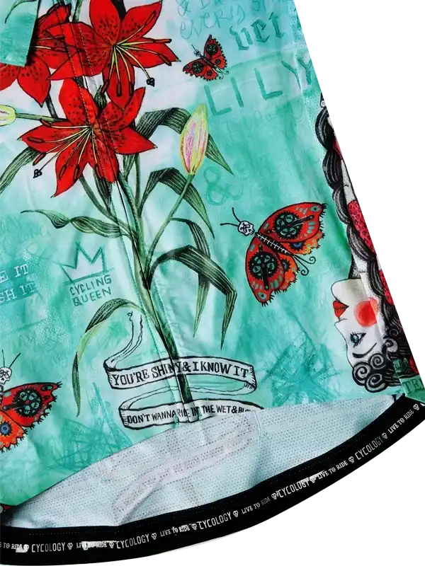 Women's cycling jersey with red lilies, butterflies, and 'Cycling Queen' graphic on mint background