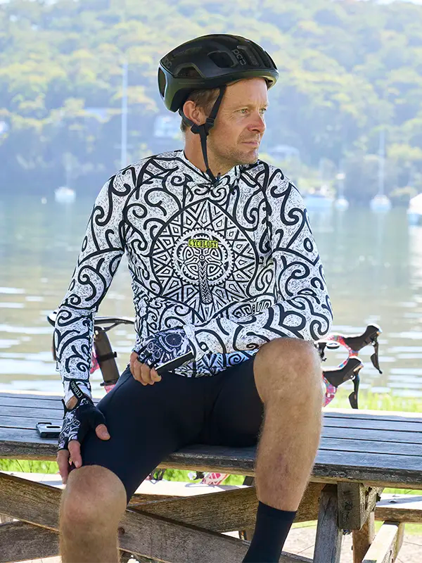 Man sitting on a bench wearing a Zanzibar Men's White Long Sleeve Summer Cycling Jersey