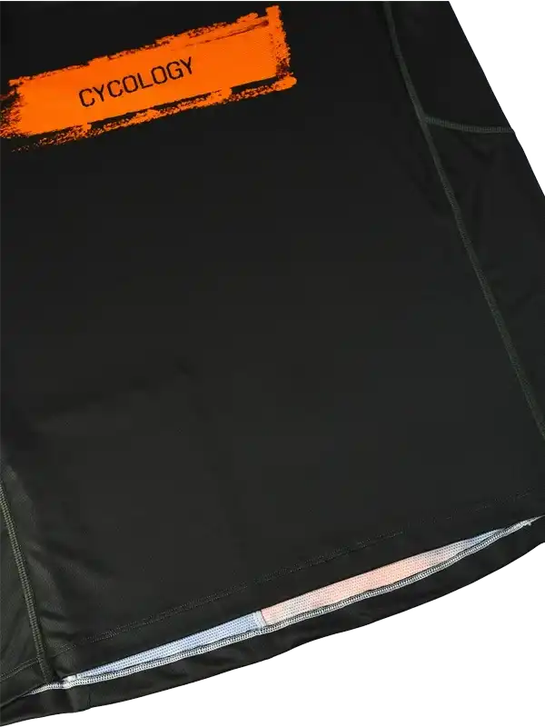 Black cycling jersey with orange Cycology logo, featuring reflective hem and performance fabric details