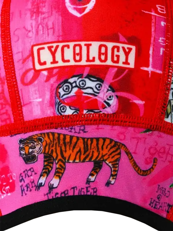 Vibrant pink and red cycling cap with tiger graphic and 'CYCOLOGY' logo, ideal for bike rides.