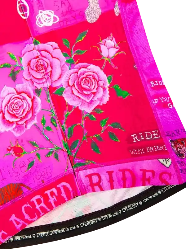 Pink cycling jersey with rose floral print and 'RIDE' text, featuring vibrant design for women's bike wear.