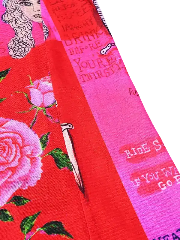 Vibrant red cycling jersey with pink roses, vintage typography, and bike graphic details for women's ride wear