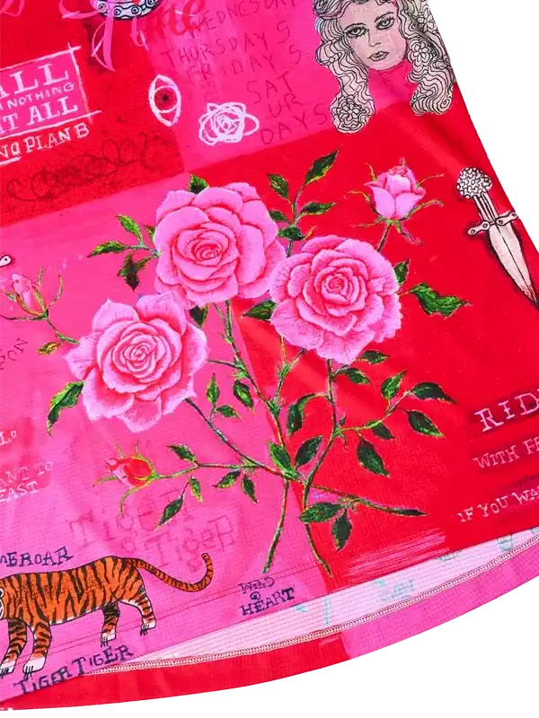 Vibrant pink cycling jersey with rose, tiger, and dagger graphics on red fabric