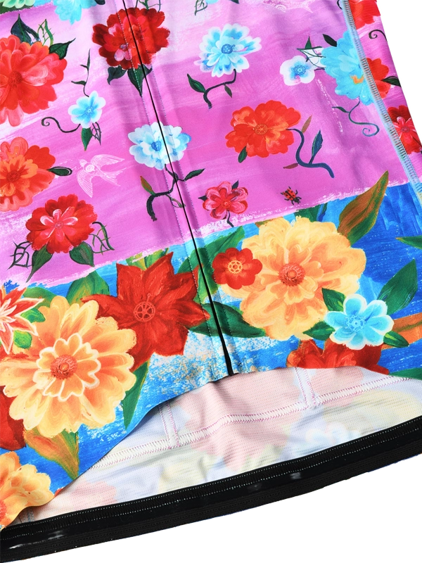 Colorful women's long sleeve cycling jersey with floral design and 'Cycology' branding on a pink and blue background