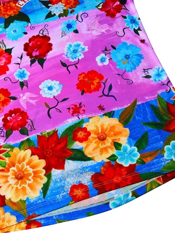 Vibrant floral cycling jersey with red, blue, and orange blooms on purple and blue background