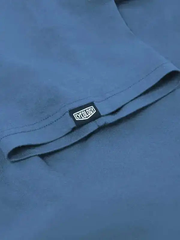 Cycology brand tag on blue cycling apparel, showcasing quality fabric and design detail