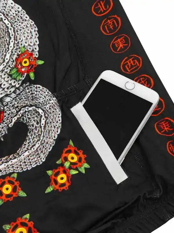 Black cycling shorts with chain and gear floral print, side pocket holding phone, orange Chinese characters