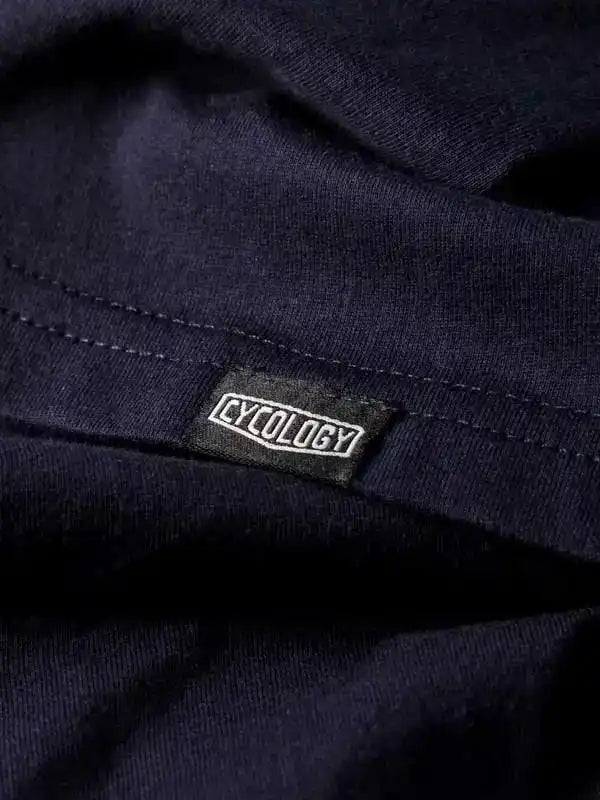 Cycology brand tag on dark navy cycling apparel, showcasing quality fabric and stitching detail