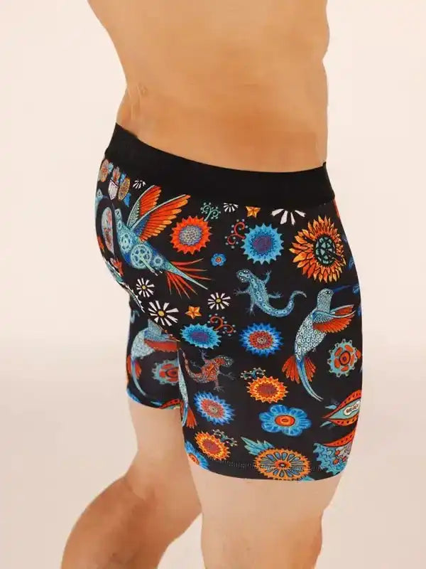 Men's cycling shorts with vibrant hummingbird and floral pattern on black fabric