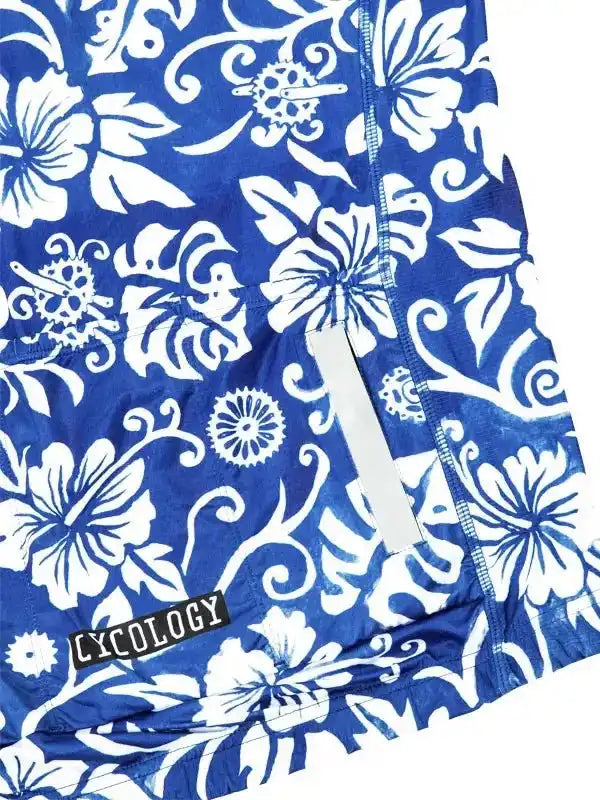 Blue cycling jersey with white floral pattern and reflective strip, featuring Lycology brand tag.