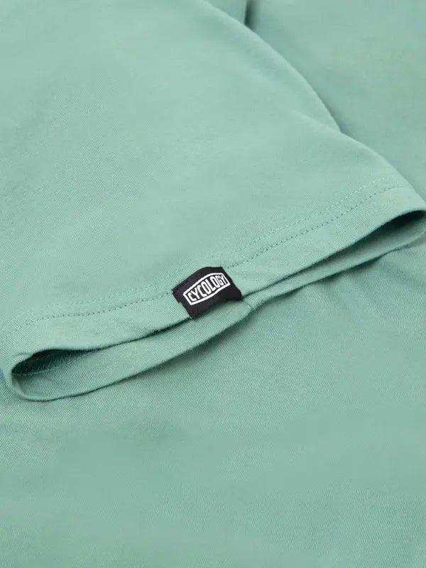 Mint green cycling jersey with branded tag, soft fabric detail for men's and women's bike wear