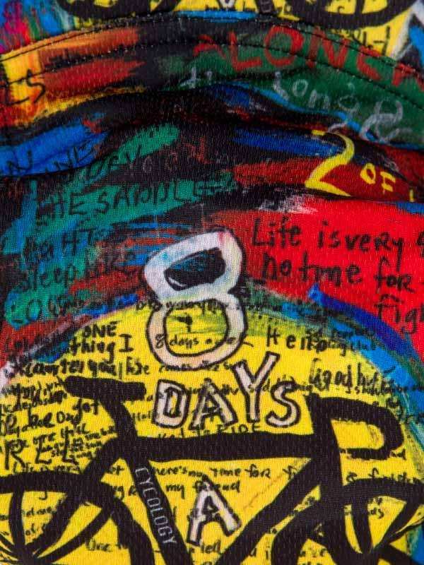 Vibrant cycling jersey with '8 Days a Ride' graphic, bold colors, and inspirational text for cyclists.