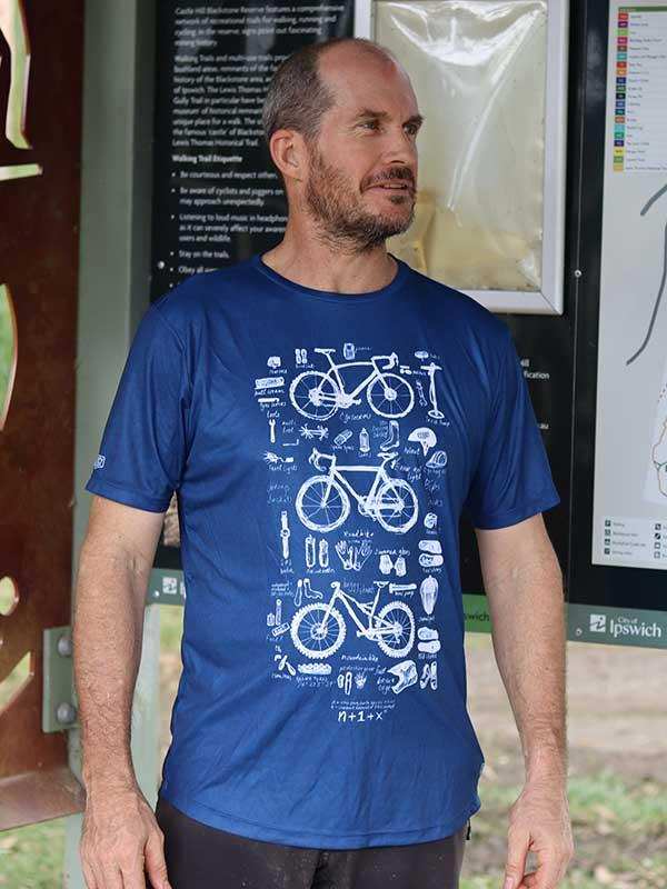 Man wearing blue cycling t-shirt with bike diagram print, ideal for cyclists and outdoor adventures