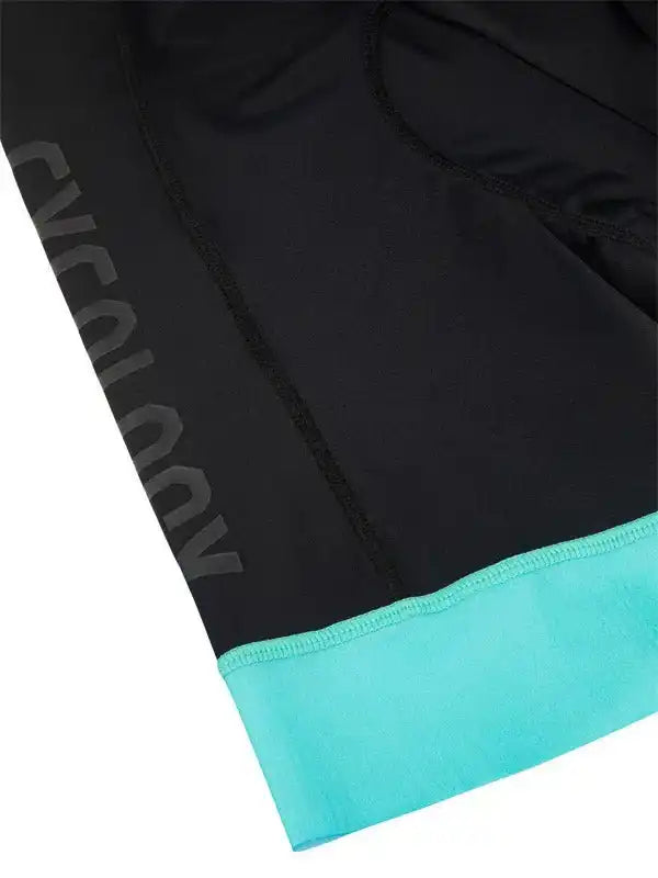 Black cycling shorts with teal hem and subtle brand logo, designed for comfort and performance.
