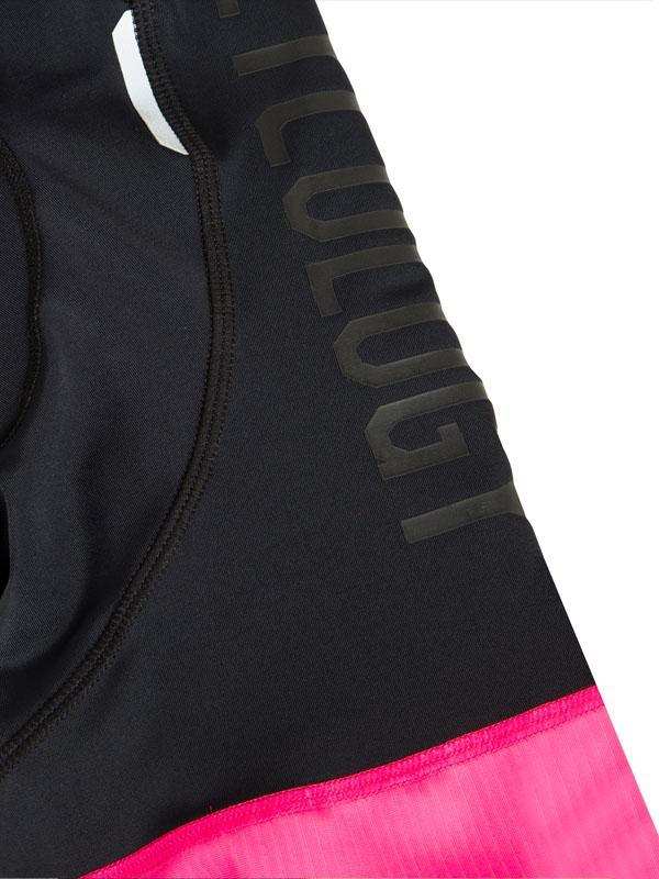 Black cycling shorts with pink hem and 'Cycology' branding, designed for performance and comfort.